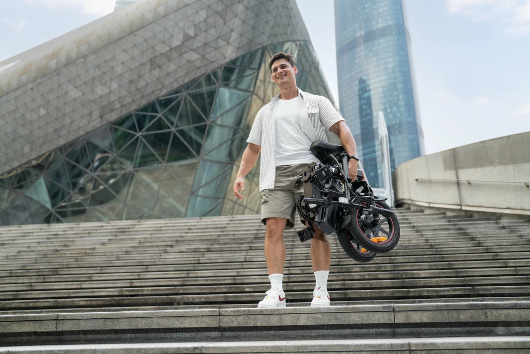 Folded DYU A5 e-bike being carried down the stairs
