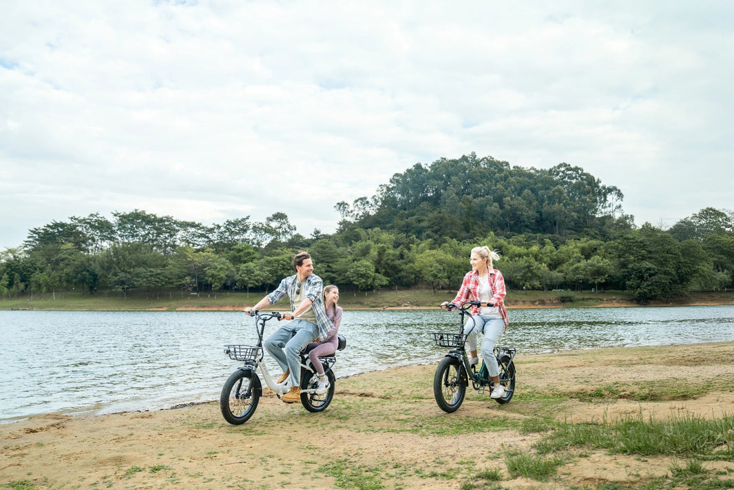 DYU C9 folding e-bike on a cool-weather route beside the water