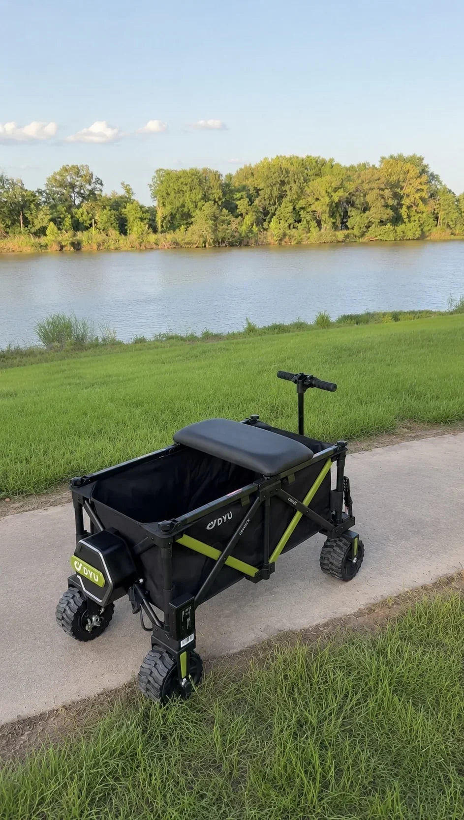DYU campX electric wagon parked by a lakeside picnic area