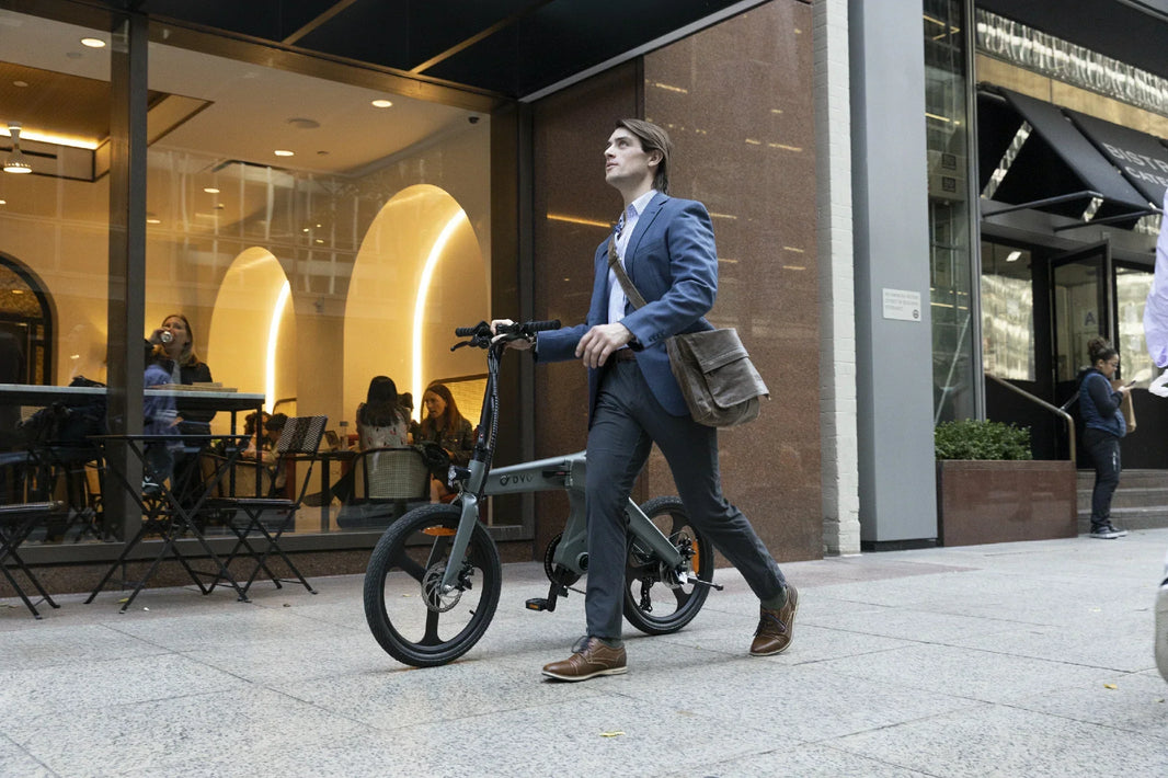 DYU T1 torque sensor e-bike ridden past an urban storefront